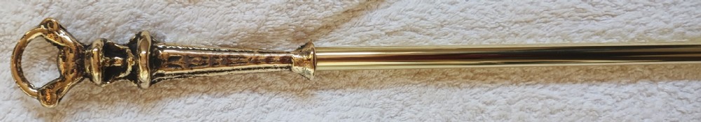 A three-piece set of Victorian brass fire irons comprising a poker, a shovel with a pierced scroll blade, and a pair of decorative tongs. View III