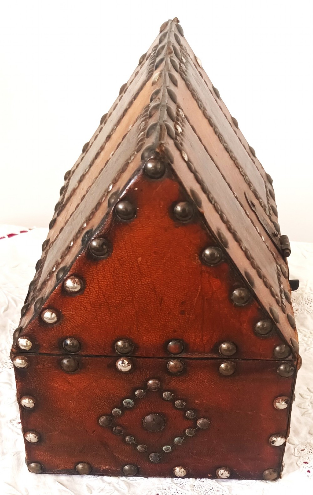 A rectangular Georgian leather-bound casket decorated with brass studs, etched military figure illustrations, and a central iron latch. View VI