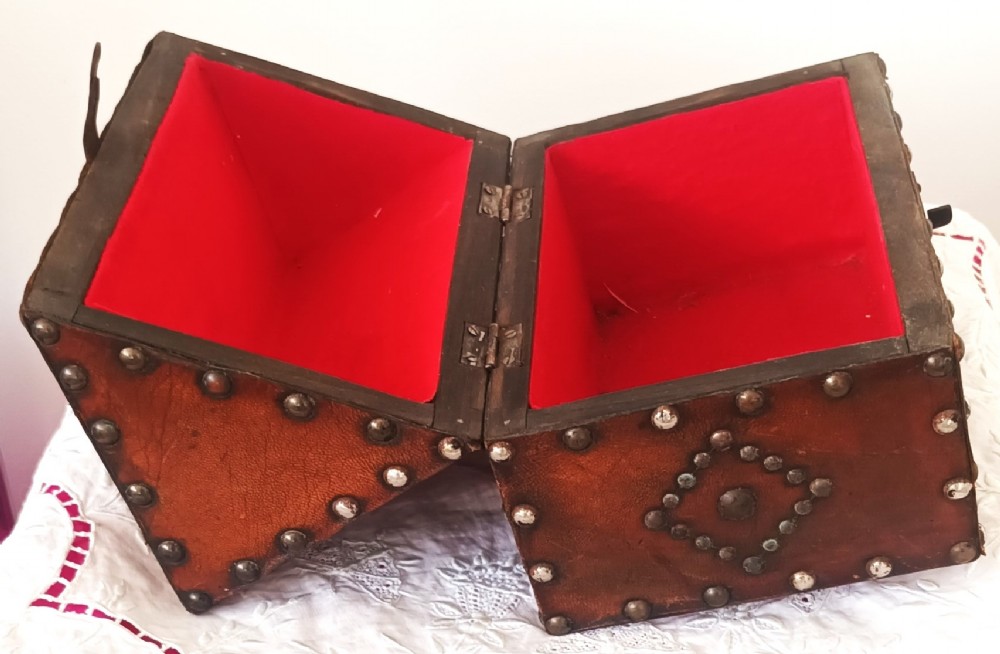 A rectangular Georgian leather-bound casket decorated with brass studs, etched military figure illustrations, and a central iron latch. View VII