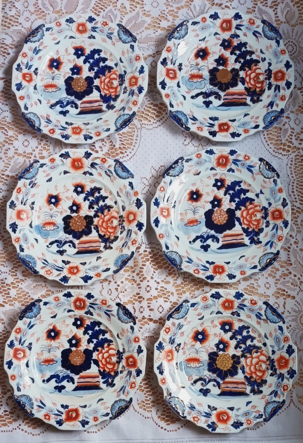 Set of six scalloped antique ironstone plates decorated with cobalt blue and terracotta floral Imari patterns with gilded details. View XIV