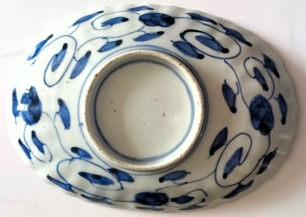 A pair of oval antique Japanese Imari porcelain dishes with scalloped rims, featuring hand-painted floral and bird motifs in cobalt blue, iron red, and white enamels. View VI