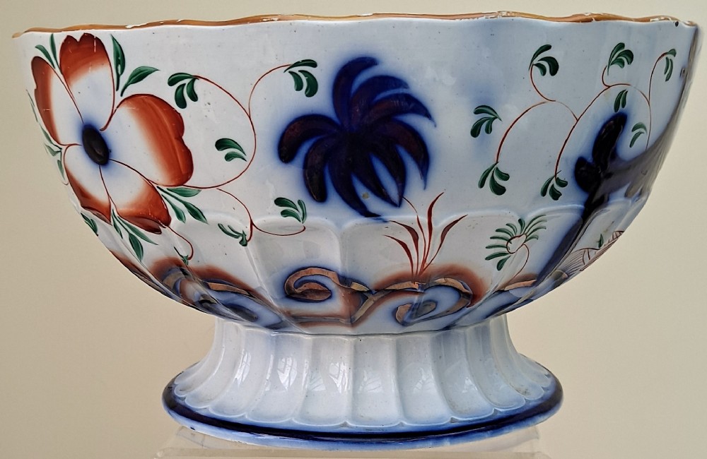 An antique Victorian earthenware footed bowl decorated with a cobalt blue and green hand-painted Pagoda pattern on a fluted pedestal base. View IV