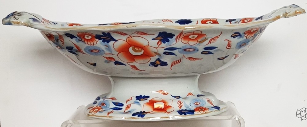 An oval ironstone footed comport decorated with an Imari Japan floral pattern in rust red, cobalt blue, and gold highlights. View III