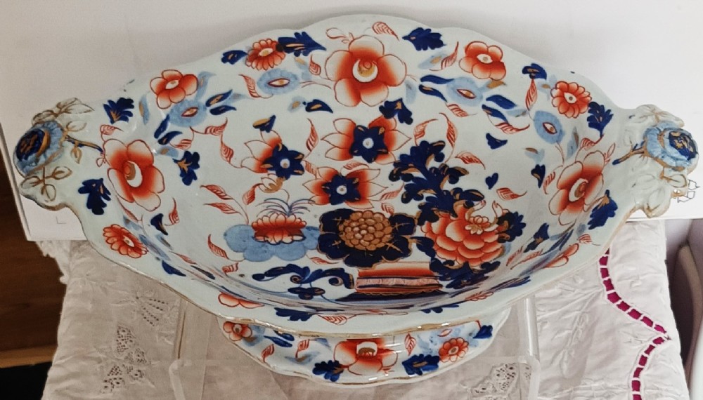 An oval ironstone footed comport decorated with an Imari Japan floral pattern in rust red, cobalt blue, and gold highlights. View IV