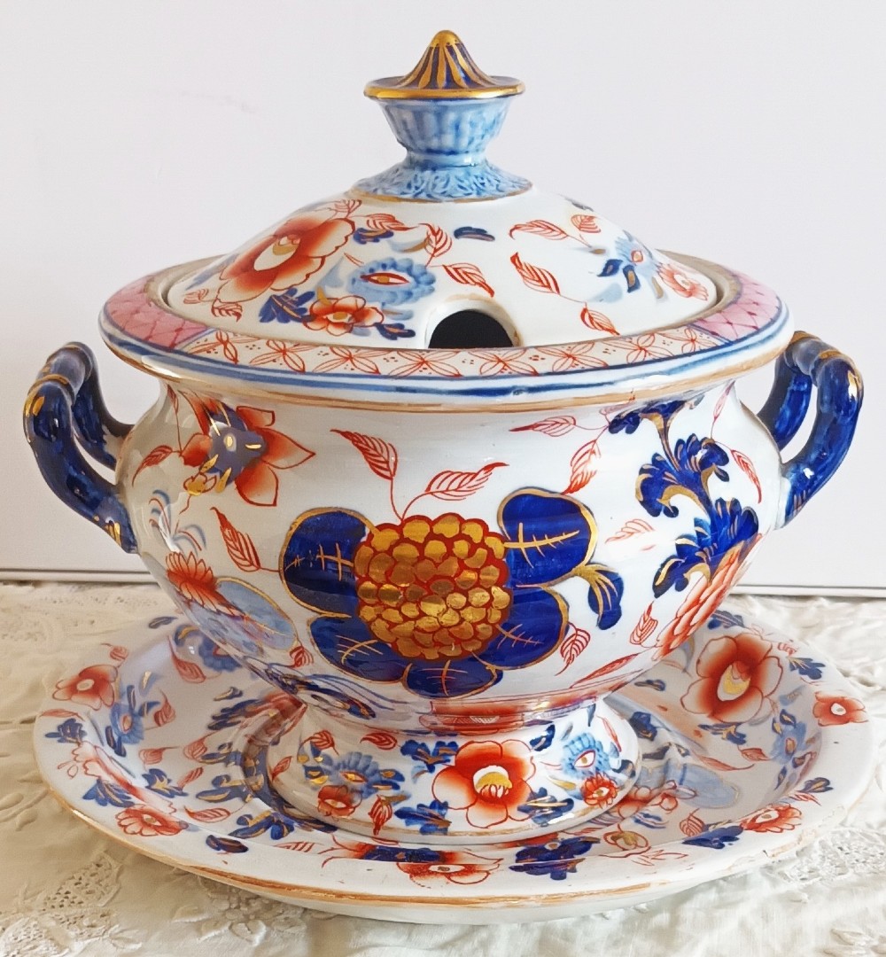 An antique Georgian ironstone china soup tureen with a lid and matching stand, decorated in an ornate Japanese Imari style pattern with cobalt blue, rust red, and gilded floral motifs. View III