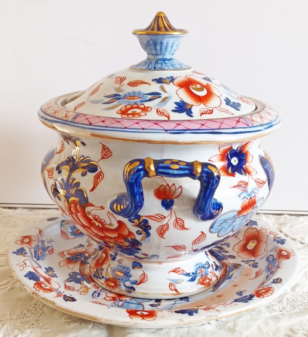 An antique Georgian ironstone china soup tureen with a lid and matching stand, decorated in an ornate Japanese Imari style pattern with cobalt blue, rust red, and gilded floral motifs. View IV