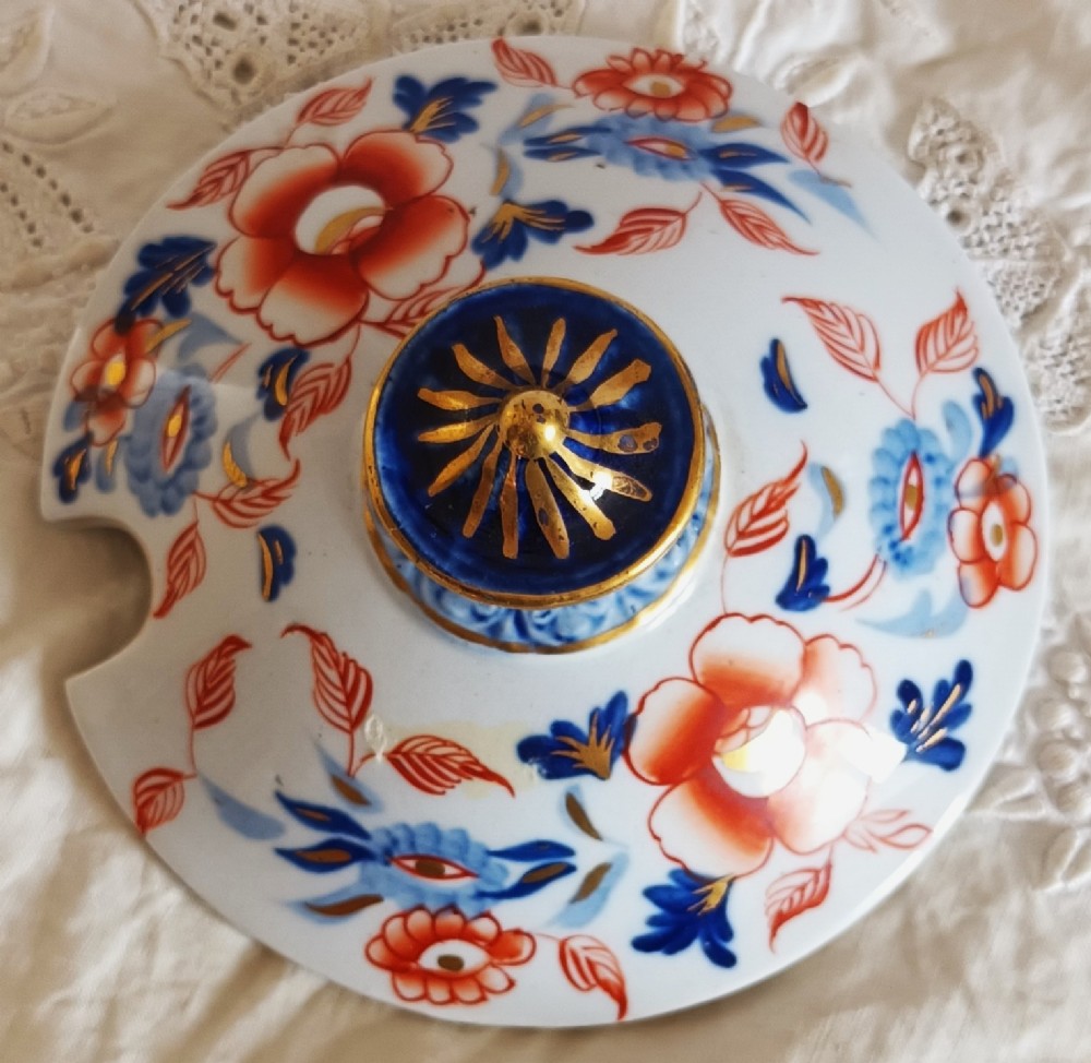 An antique Georgian ironstone china soup tureen with a lid and matching stand, decorated in an ornate Japanese Imari style pattern with cobalt blue, rust red, and gilded floral motifs. View X