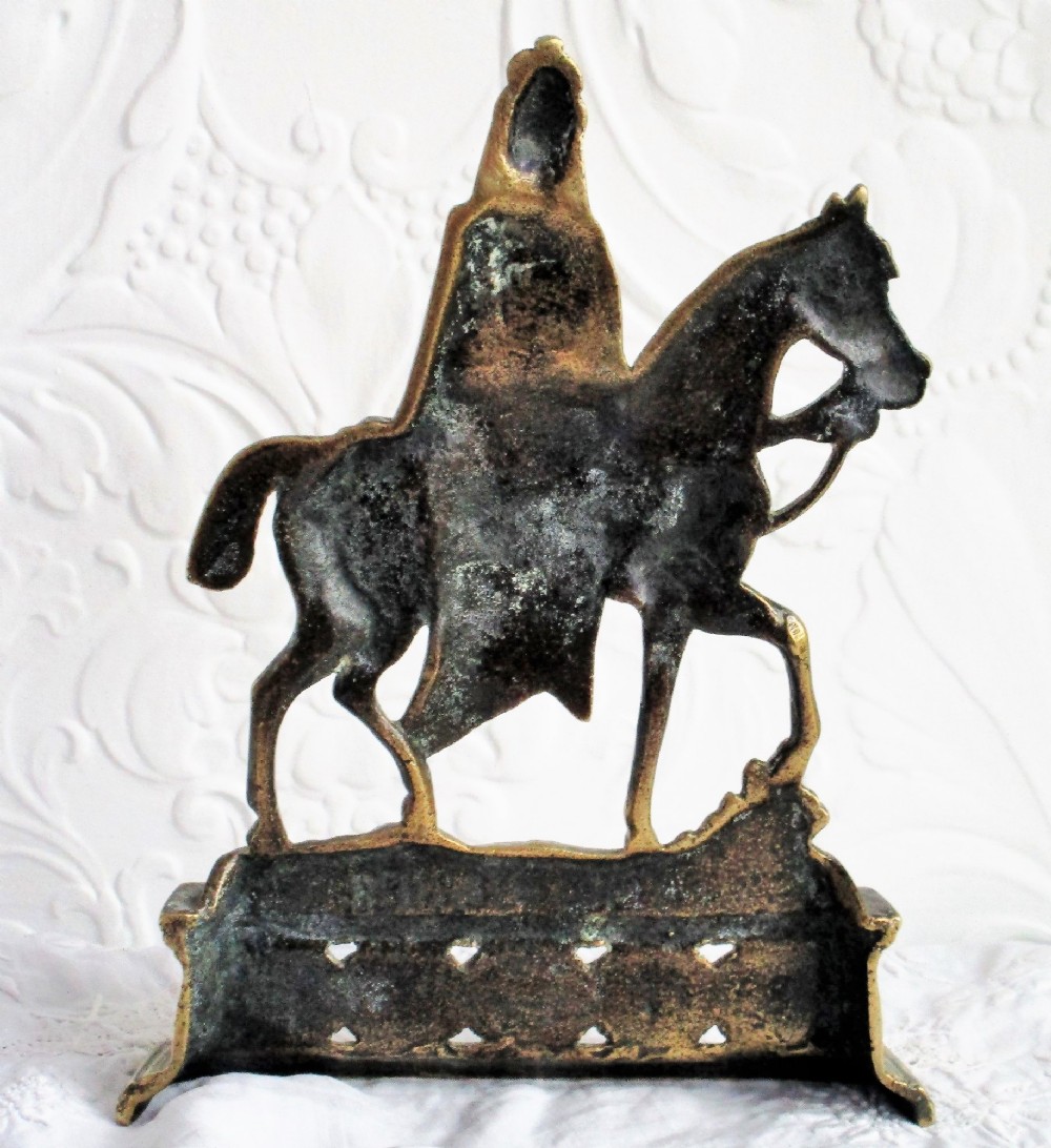 A pair of cast brass equestrian chimney ornaments depicting King Edward VII and Queen Alexandra mounted on horseback atop inscribed plinths. View V