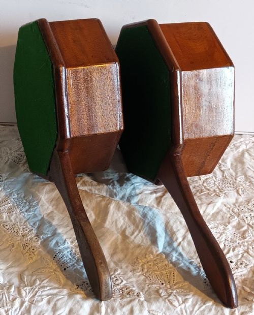 fig 2. A pair of antique octagonal wooden alms dishes with extended carved handles, crafted in warm brown timber.