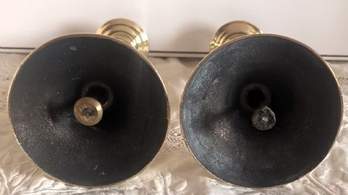 fig 1. A pair of polished gold brass candlesticks featuring baluster turned stems and stepped circular bases.