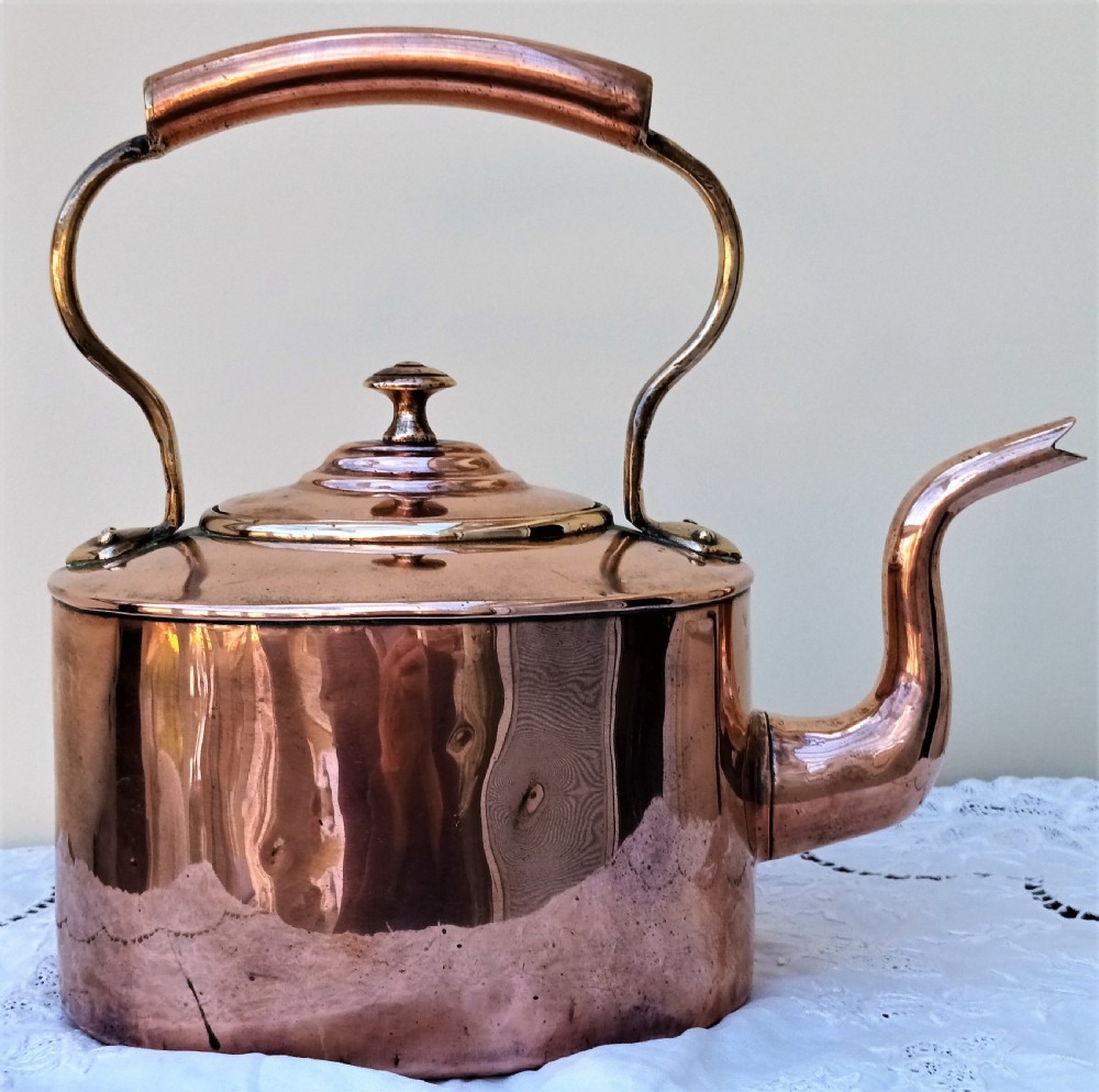 A polished Victorian copper kettle featuring a gooseneck spout, fitted circular lid with finial, and fixed overhead handle. View III