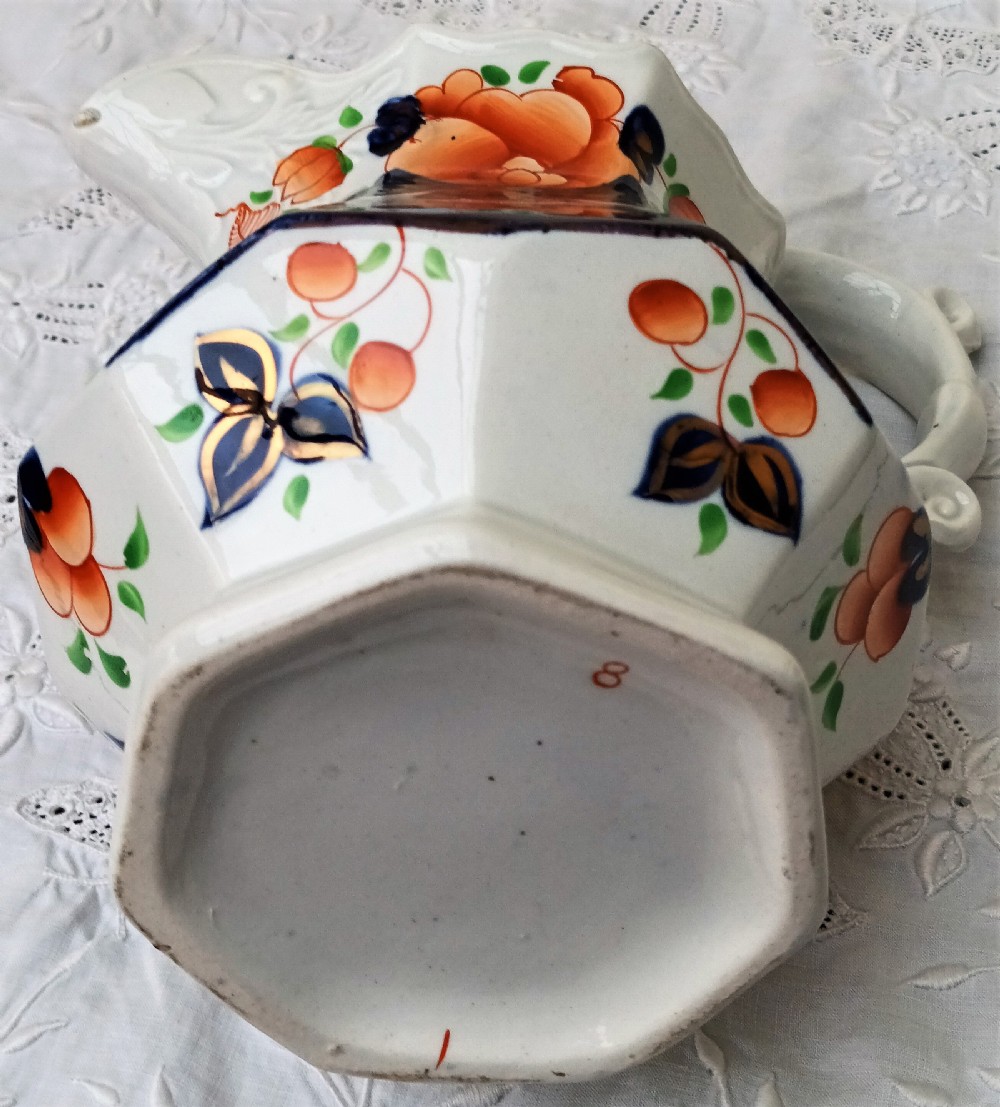 A Victorian Gaudy Welsh earthenware jug decorated with the hand-painted Cambrian Rose pattern in cobalt blue, orange, and green on an octagonal white body. View VI