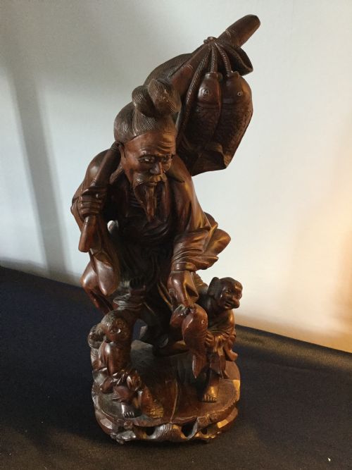 An Oriental Carved Hardwood Group C1900