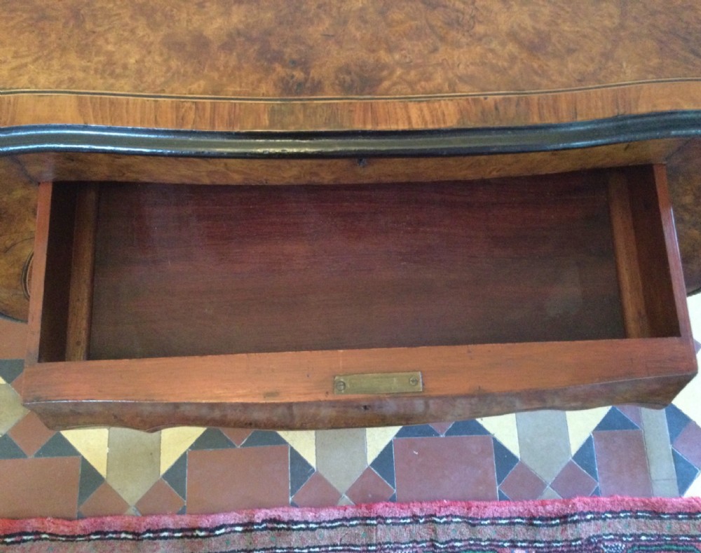 A late 19th-century burr walnut side table featuring serpentine edges, cabriole legs trimmed with brass studs, and a figured wood grain surface. View V