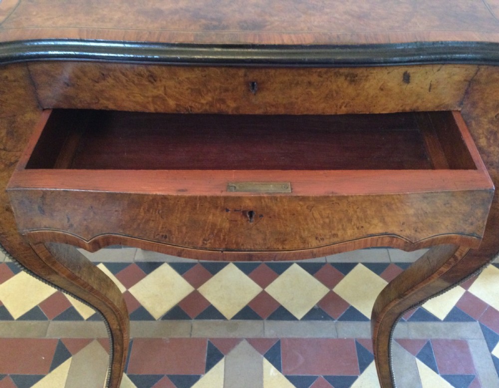 A late 19th-century burr walnut side table featuring serpentine edges, cabriole legs trimmed with brass studs, and a figured wood grain surface. View VI