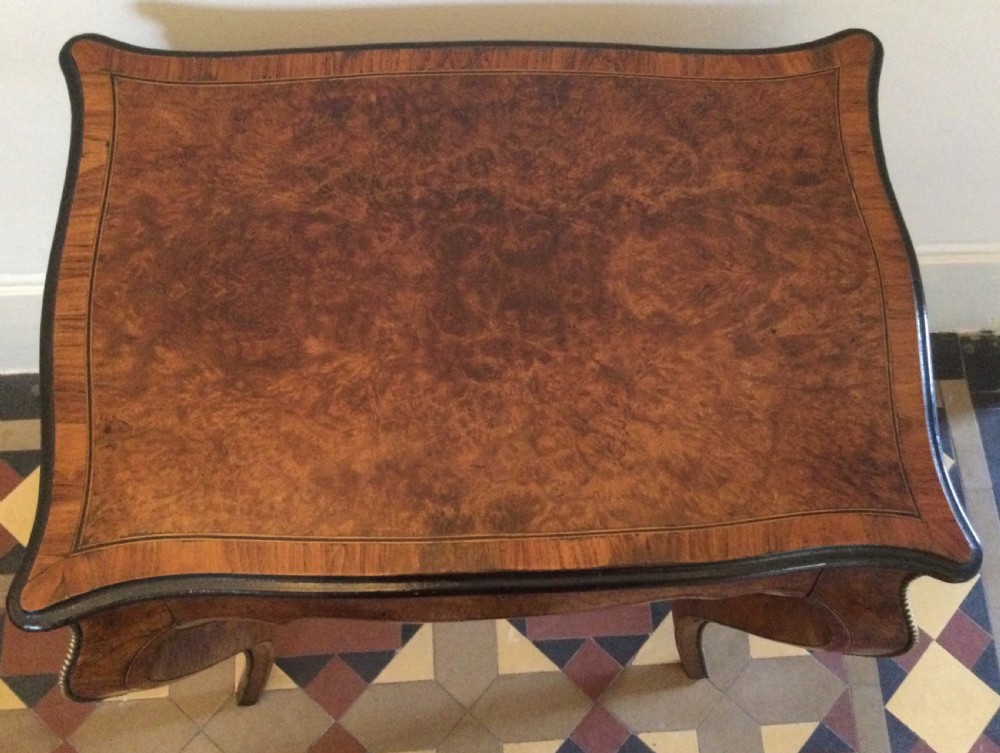 A late 19th-century burr walnut side table featuring serpentine edges, cabriole legs trimmed with brass studs, and a figured wood grain surface. View VIII
