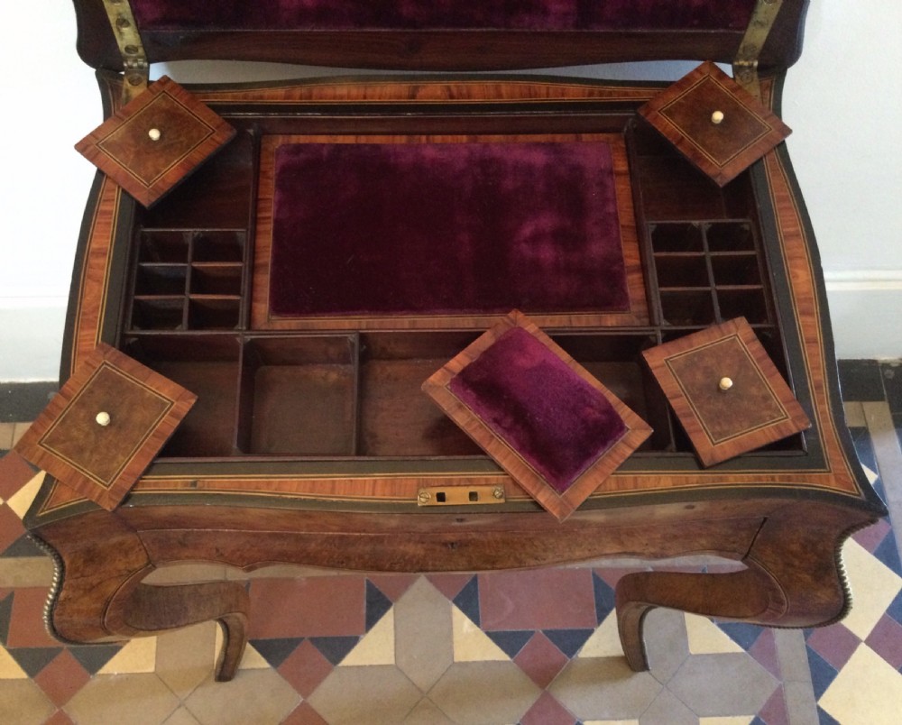 A late 19th-century burr walnut side table featuring serpentine edges, cabriole legs trimmed with brass studs, and a figured wood grain surface. View IX