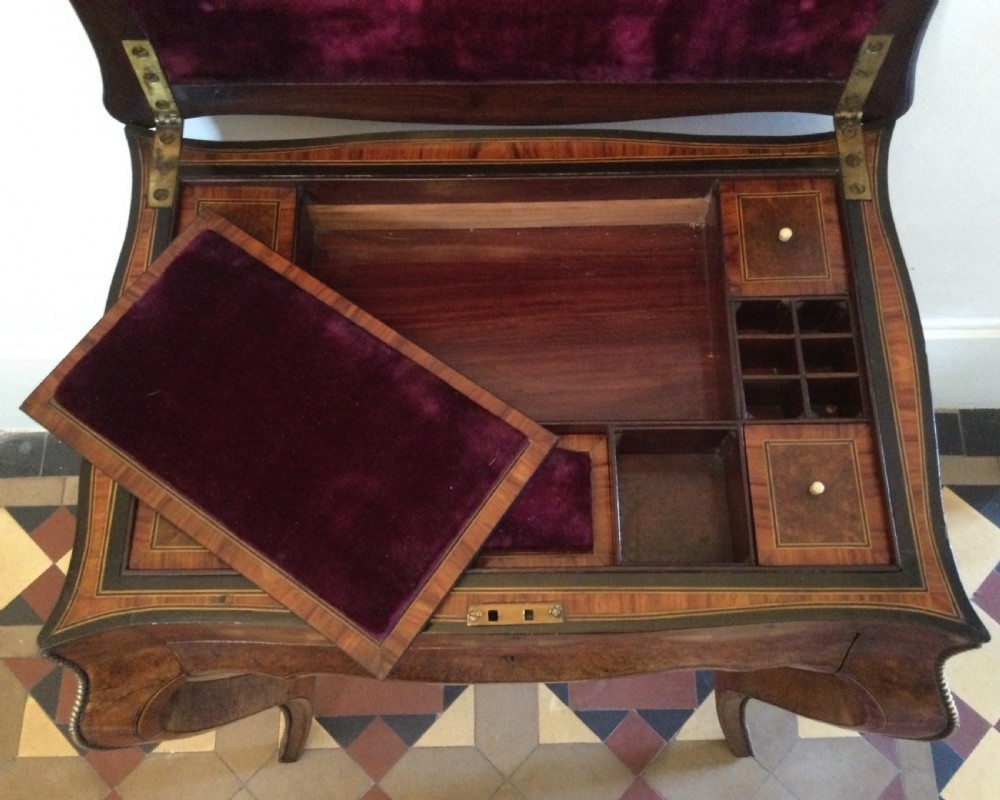 A late 19th-century burr walnut side table featuring serpentine edges, cabriole legs trimmed with brass studs, and a figured wood grain surface. View X