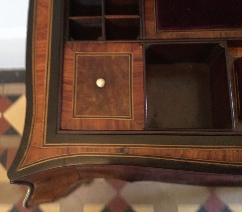 A late 19th-century burr walnut side table featuring serpentine edges, cabriole legs trimmed with brass studs, and a figured wood grain surface. View XII