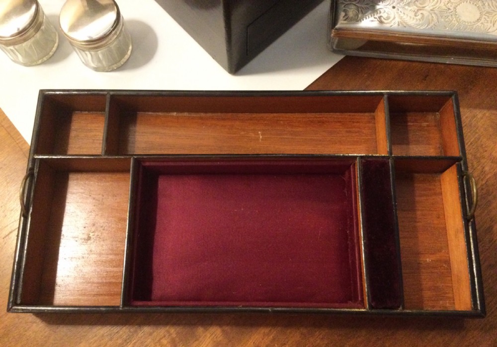 An early Victorian rectangular dark brown coromandel wood box featuring mother-of-pearl inlaid shield and crest motifs on the top lid and front panel. View IX