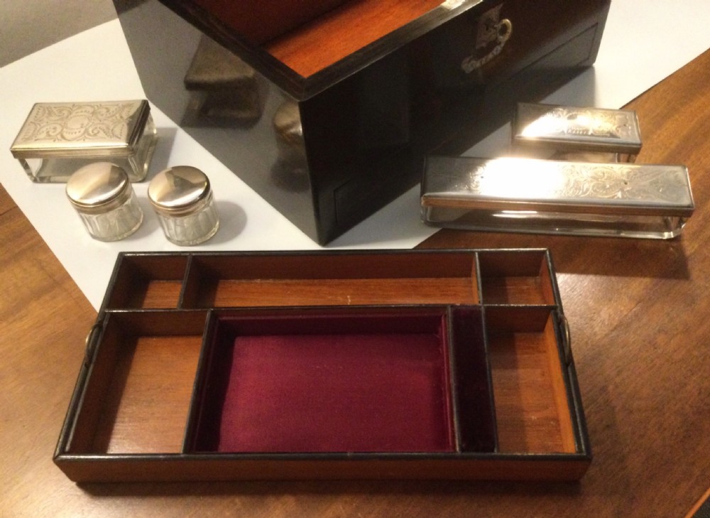 An early Victorian rectangular dark brown coromandel wood box featuring mother-of-pearl inlaid shield and crest motifs on the top lid and front panel. View XI