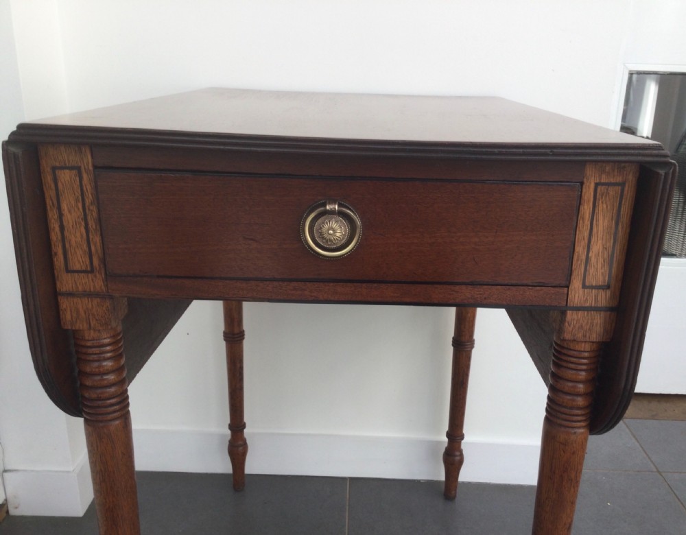 A Georgian mahogany drop leaf side table featuring a single drawer with a brass ring handle, inlaid border detailing, turned legs, and two hinged drop leaves. View II