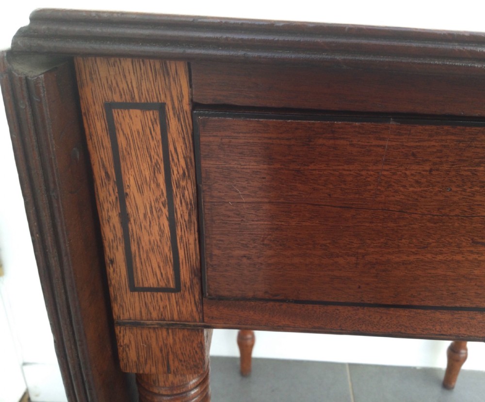 A Georgian mahogany drop leaf side table featuring a single drawer with a brass ring handle, inlaid border detailing, turned legs, and two hinged drop leaves. View III