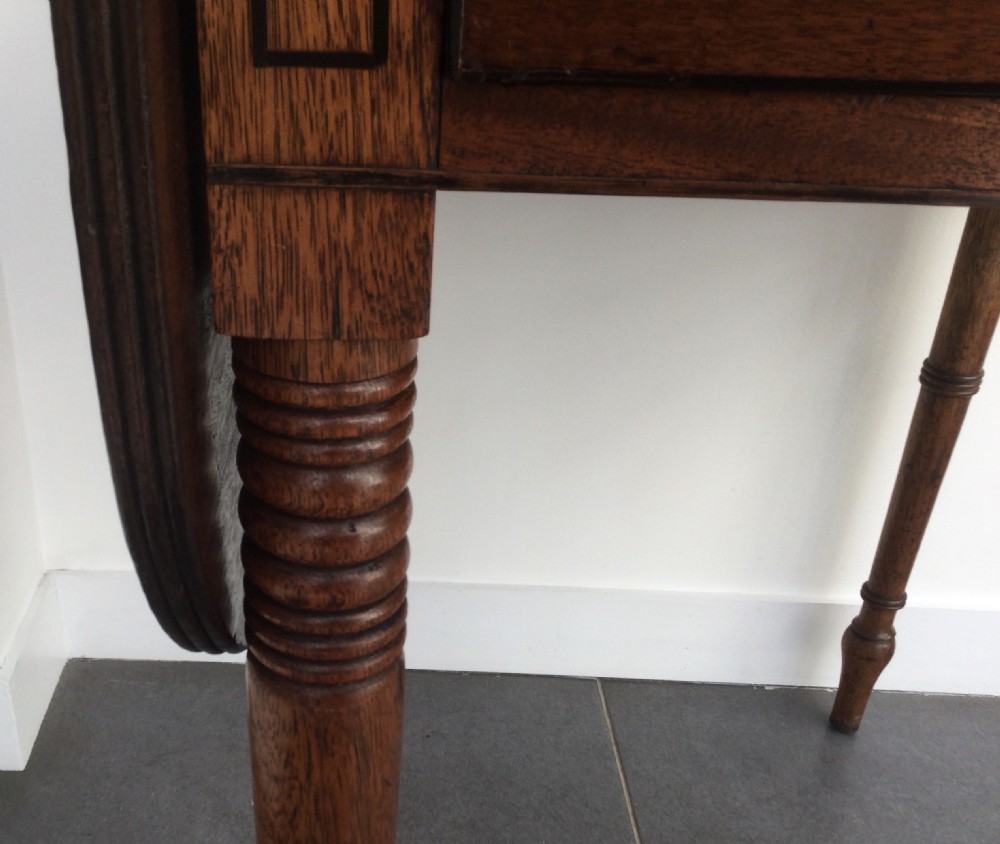 A Georgian mahogany drop leaf side table featuring a single drawer with a brass ring handle, inlaid border detailing, turned legs, and two hinged drop leaves. View IV