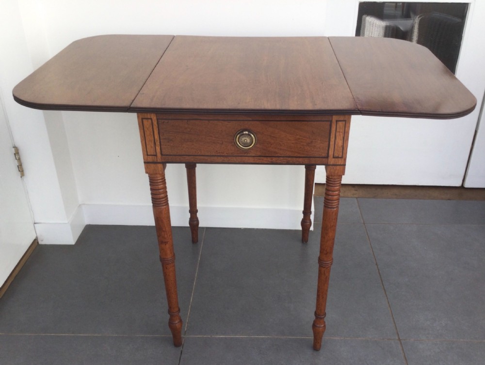 A Georgian mahogany drop leaf side table featuring a single drawer with a brass ring handle, inlaid border detailing, turned legs, and two hinged drop leaves. View VIII