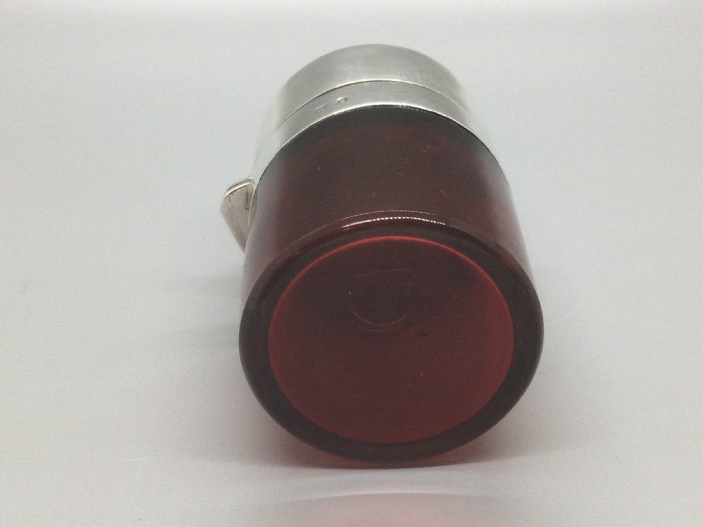 A Victorian cylindrical cranberry red glass scent bottle featuring a polished sterling silver domed lid. View XIV