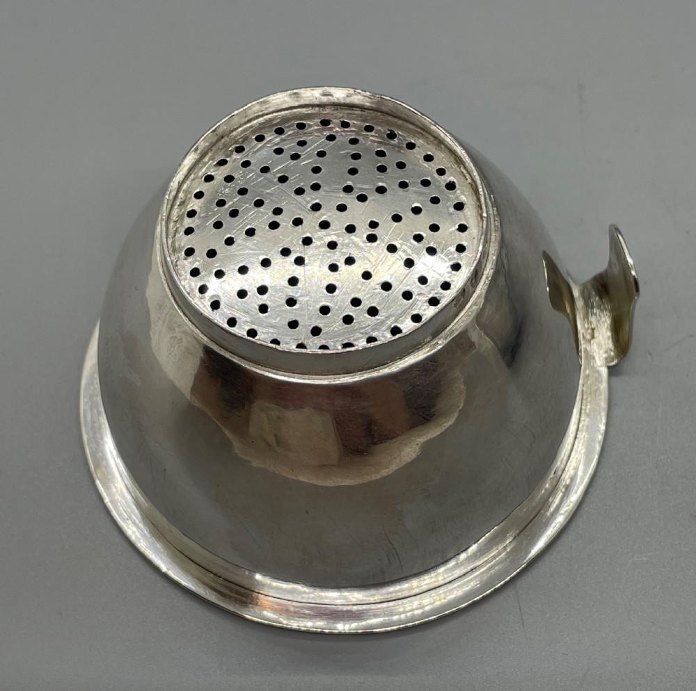 A sterling silver George III wine funnel featuring a reeded rim, side clip, curved spout, and London hallmarks. View VII