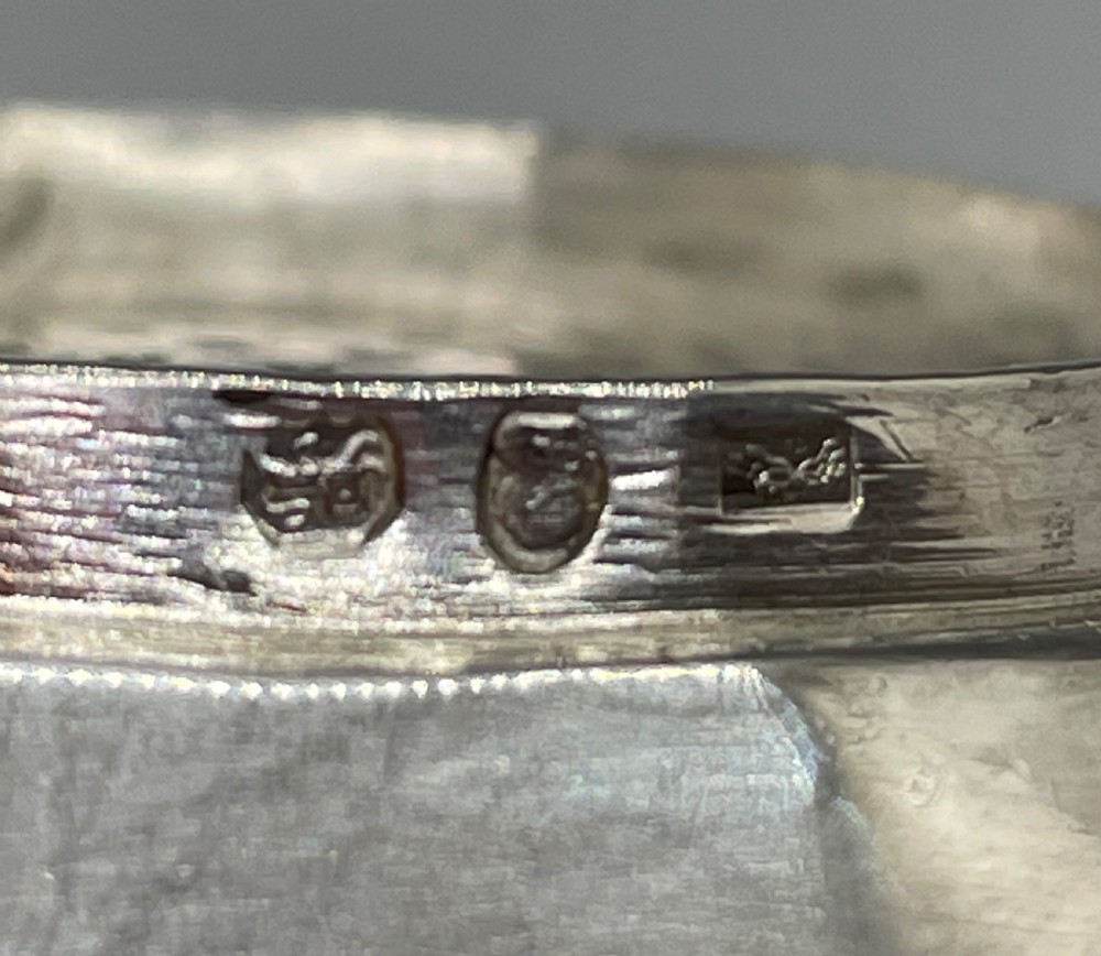 A sterling silver George III wine funnel featuring a reeded rim, side clip, curved spout, and London hallmarks. View IX