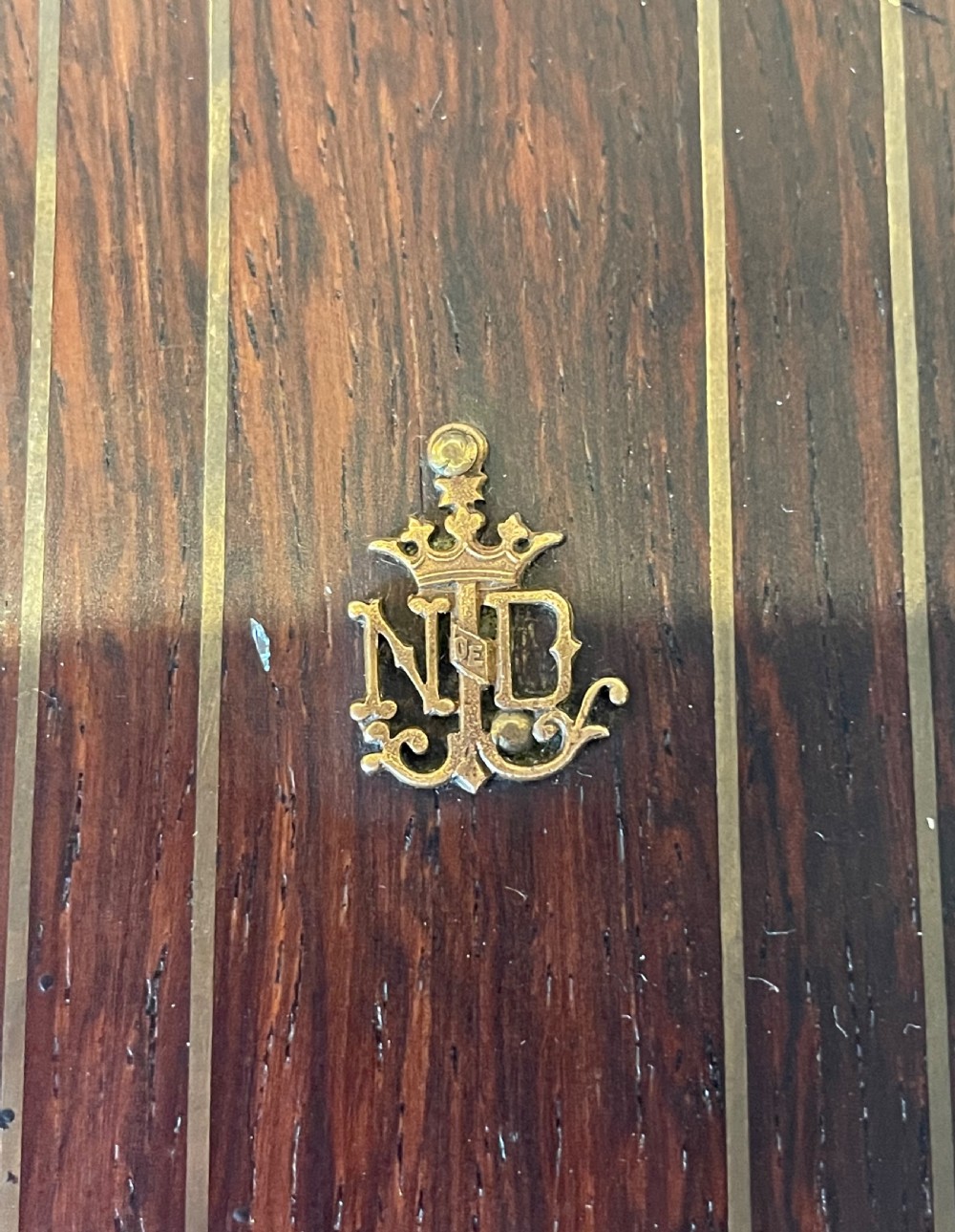 A dark rosewood wall crucifix featuring brass linear inlay, an ornate INRI plaque, a gilt metal figure of Christ, and a monogram emblem near the base. View III