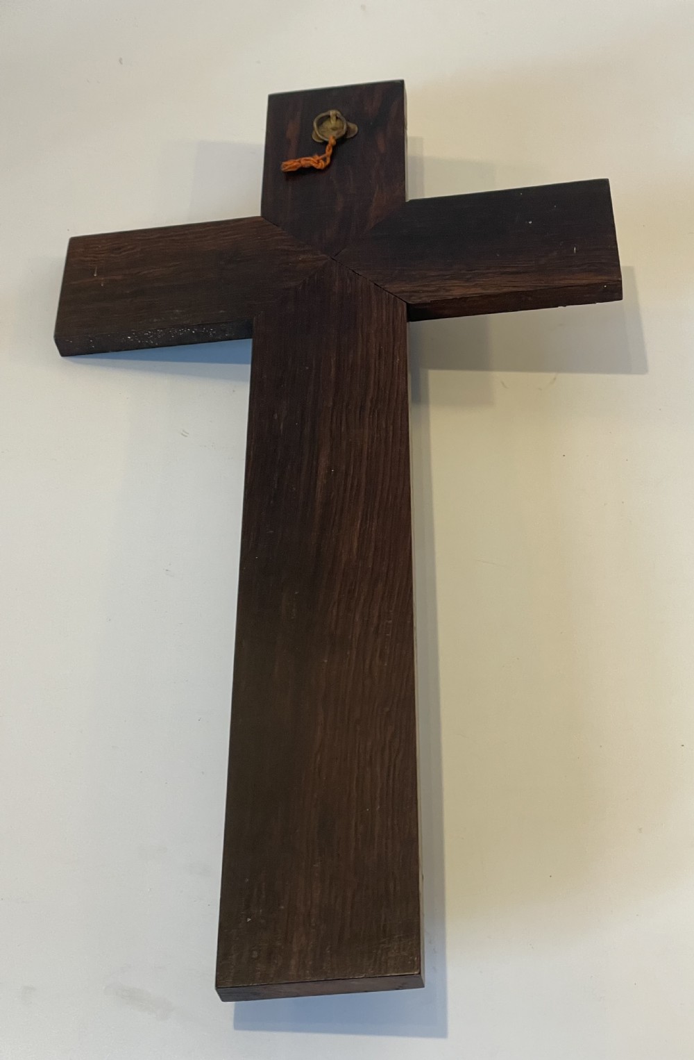 A dark rosewood wall crucifix featuring brass linear inlay, an ornate INRI plaque, a gilt metal figure of Christ, and a monogram emblem near the base. View V