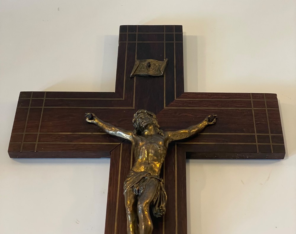 A dark rosewood wall crucifix featuring brass linear inlay, an ornate INRI plaque, a gilt metal figure of Christ, and a monogram emblem near the base. View VII