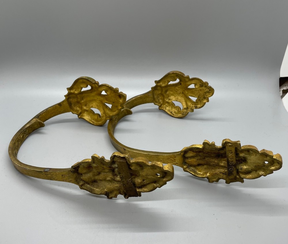 A pair of late nineteenth-century French ormolu curtain tiebacks featuring acanthus leaf scrollwork and beaded detail. View IV