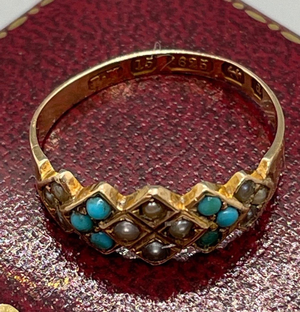 A late Victorian 15ct yellow gold ring set with blue turquoise cabochons and split seed pearls in a geometric diamond setting. View IV