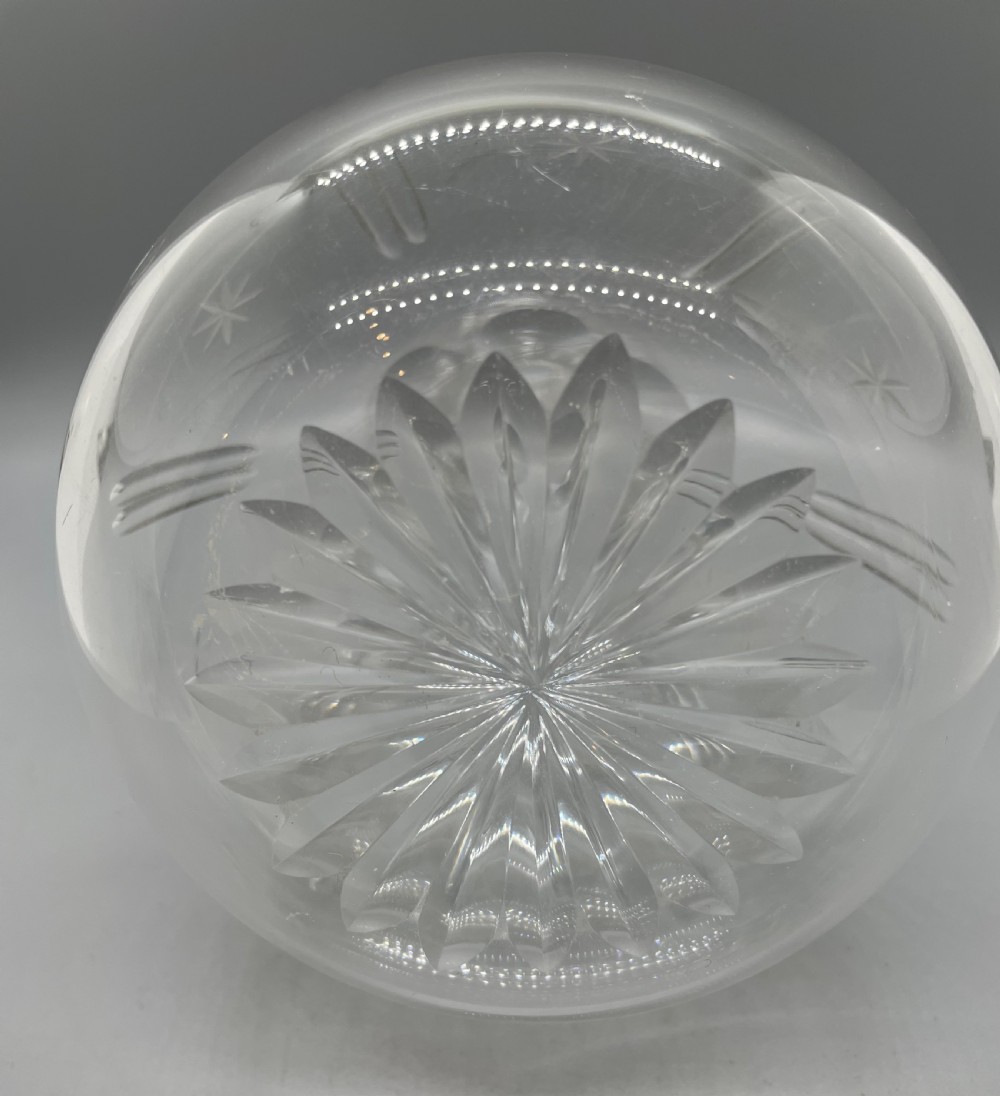 A pair of Victorian clear cut crystal decanters featuring starburst geometric engravings, fluted necks, and matching round cut glass stoppers. View X