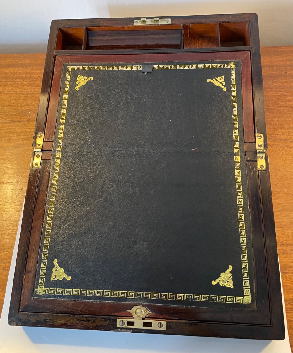 A dark brown rosewood rectangular writing slope decorated with floral mother of pearl inlay on the corners, lid centre, and lock escutcheon. View IV