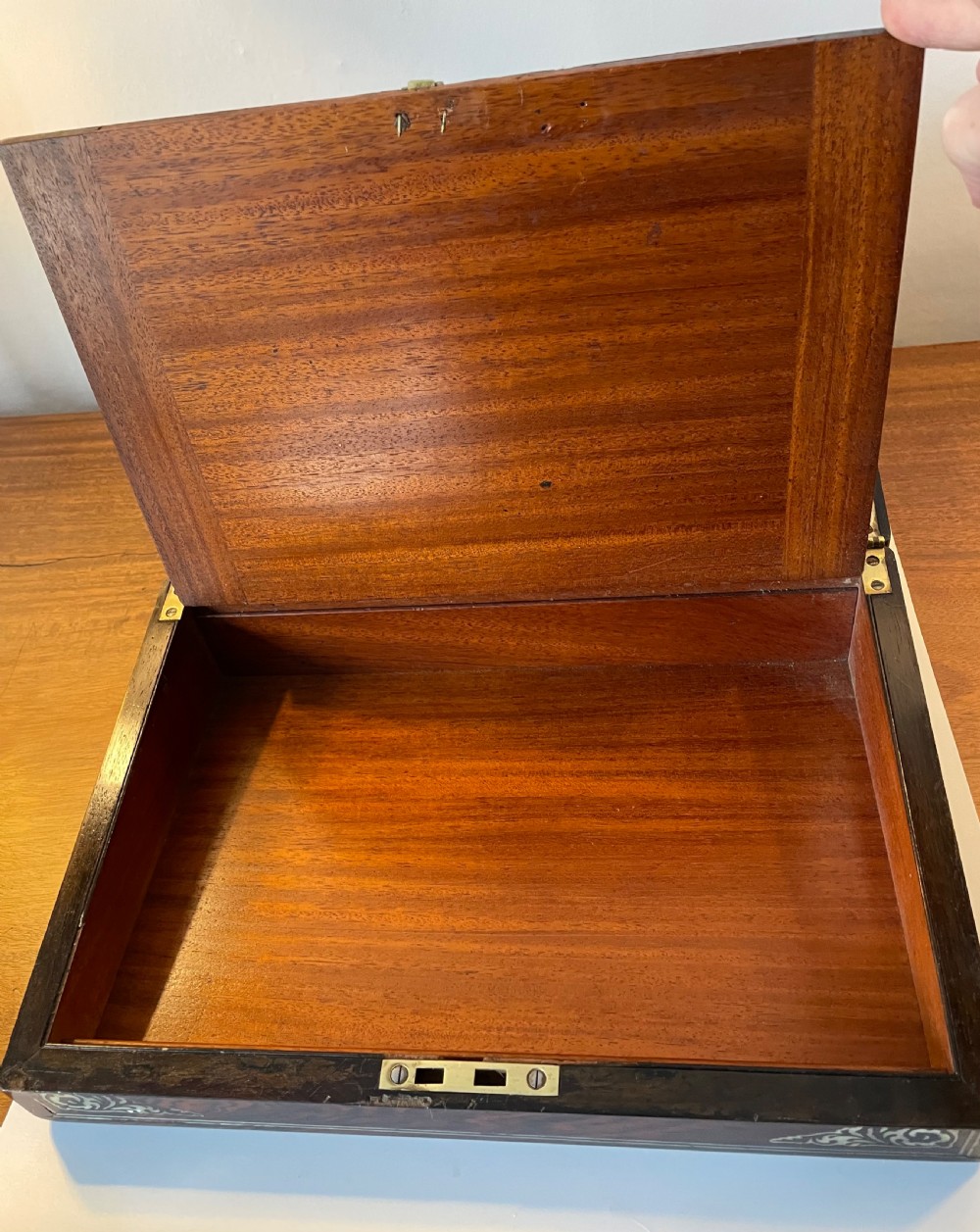 A dark brown rosewood rectangular writing slope decorated with floral mother of pearl inlay on the corners, lid centre, and lock escutcheon. View XIV