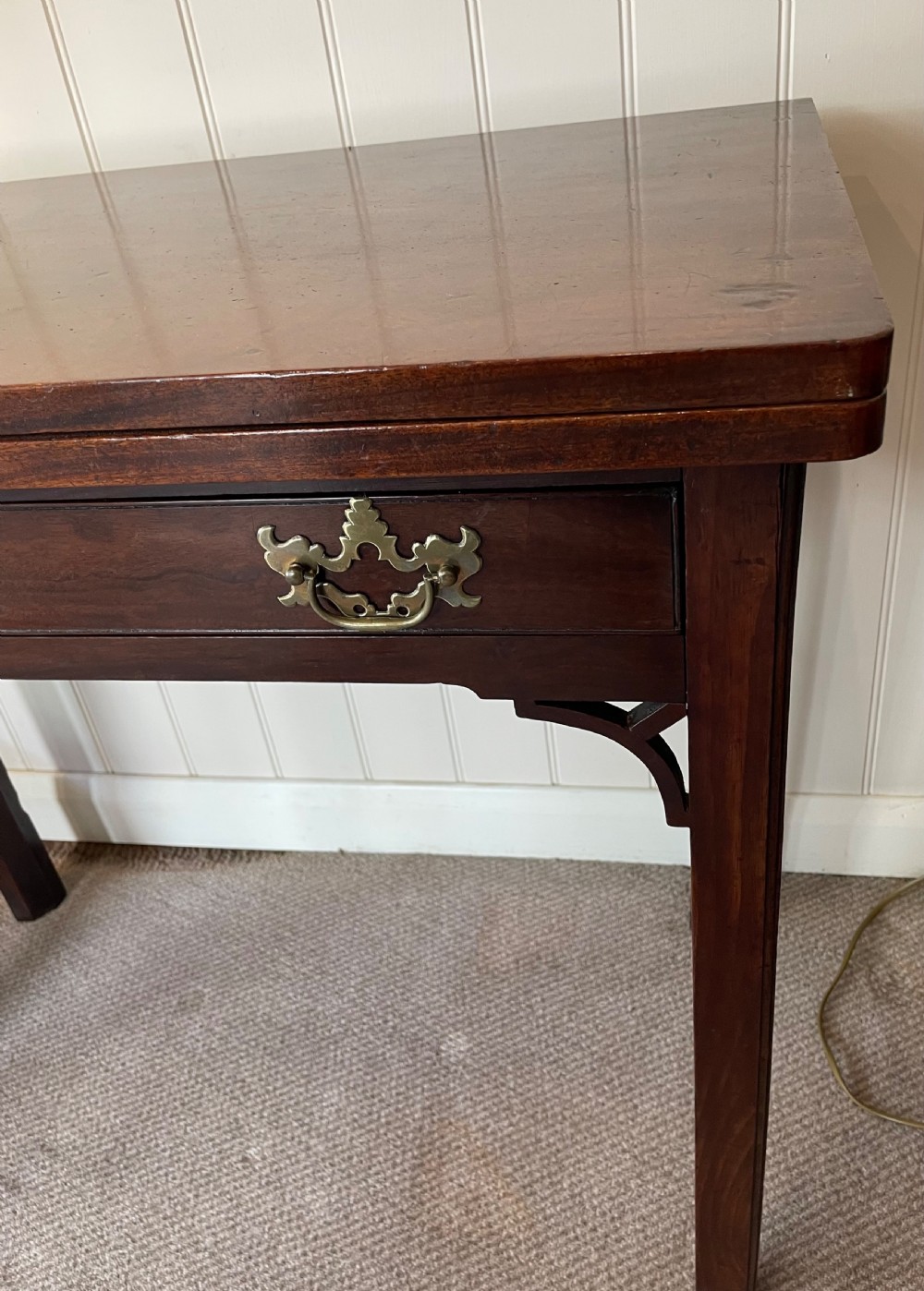 A Georgian mahogany fold-over tea table featuring straight square legs with subtle corner brackets and brass drop handles. View IV