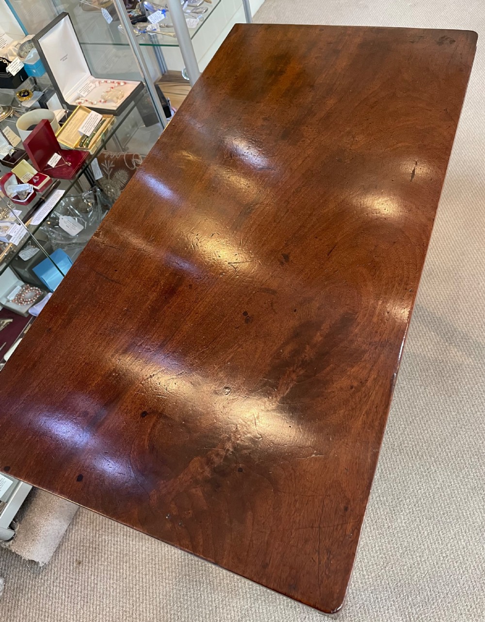 A Georgian mahogany fold-over tea table featuring straight square legs with subtle corner brackets and brass drop handles. View VIII