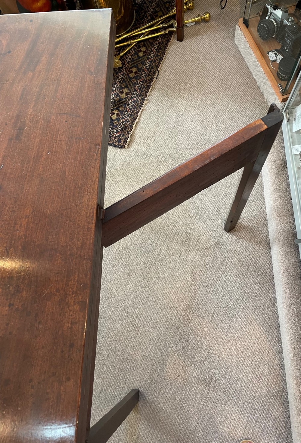 A Georgian mahogany fold-over tea table featuring straight square legs with subtle corner brackets and brass drop handles. View IX