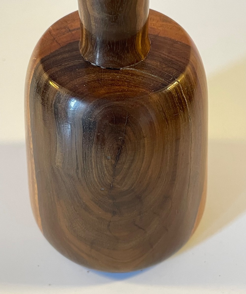 A 19th-century turned lignum vitae mallet featuring a rounded head and cylindrical handle with distinctive contrasting dark brown and light tan wood grain. View VII