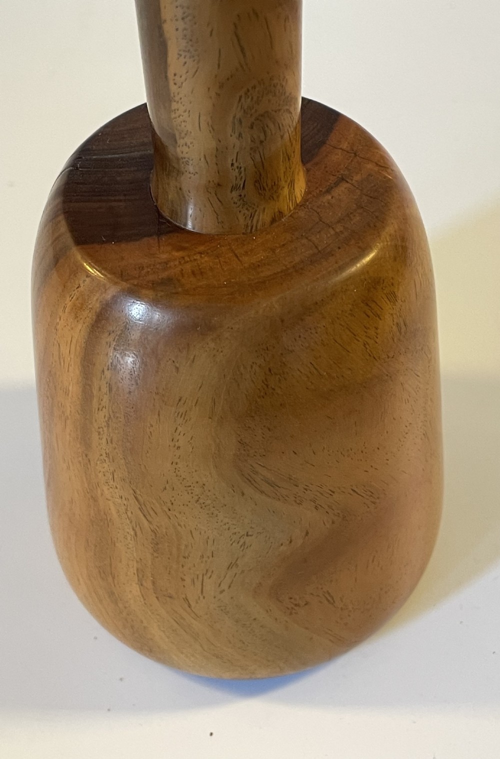 A 19th-century turned lignum vitae mallet featuring a rounded head and cylindrical handle with distinctive contrasting dark brown and light tan wood grain. View VIII