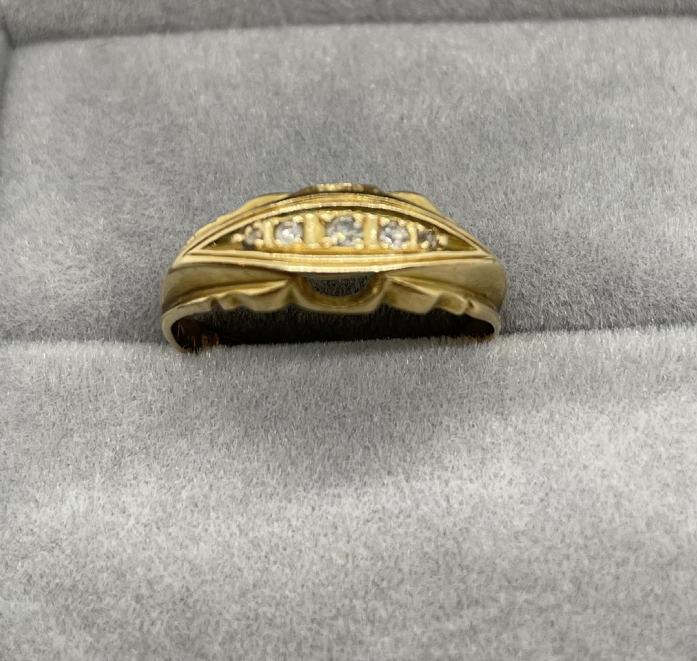 An antique 18ct yellow gold ring featuring a row of inset diamonds set within a carved boat-shaped head. View II