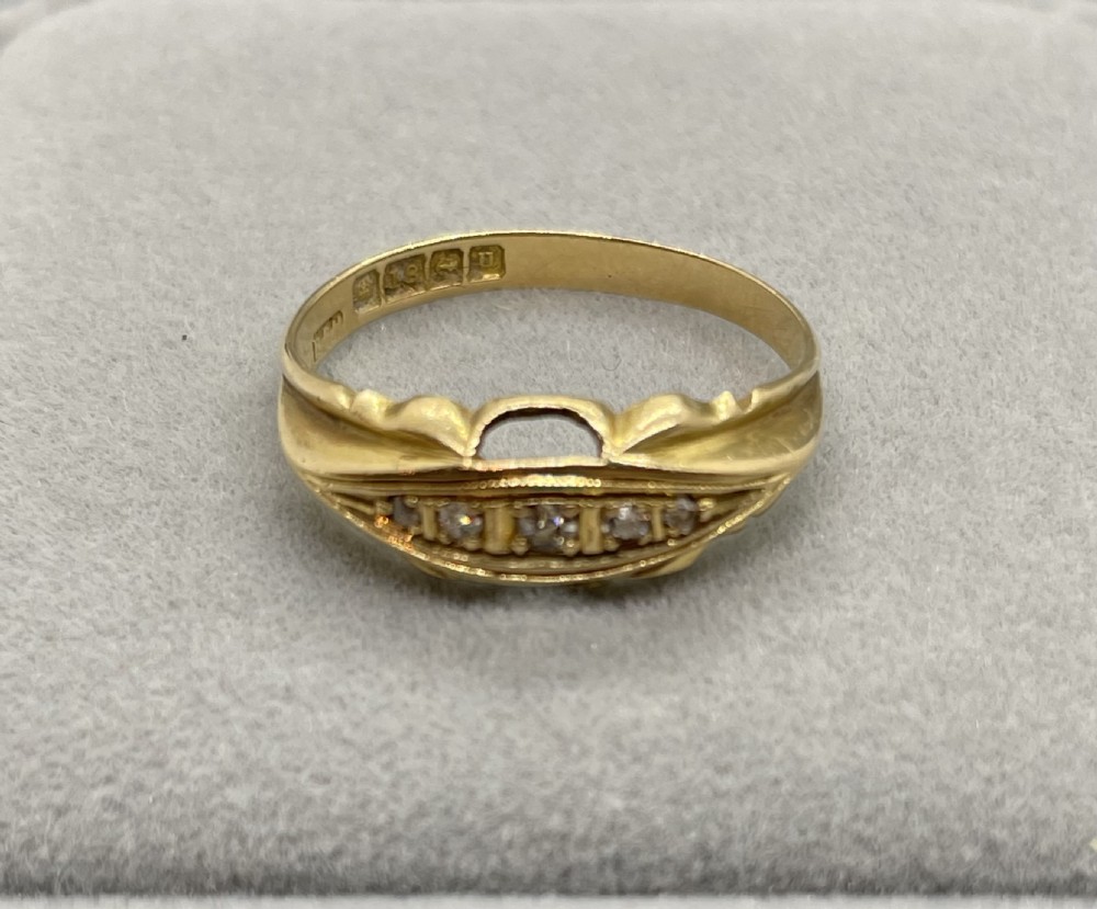 An antique 18ct yellow gold ring featuring a row of inset diamonds set within a carved boat-shaped head. View III