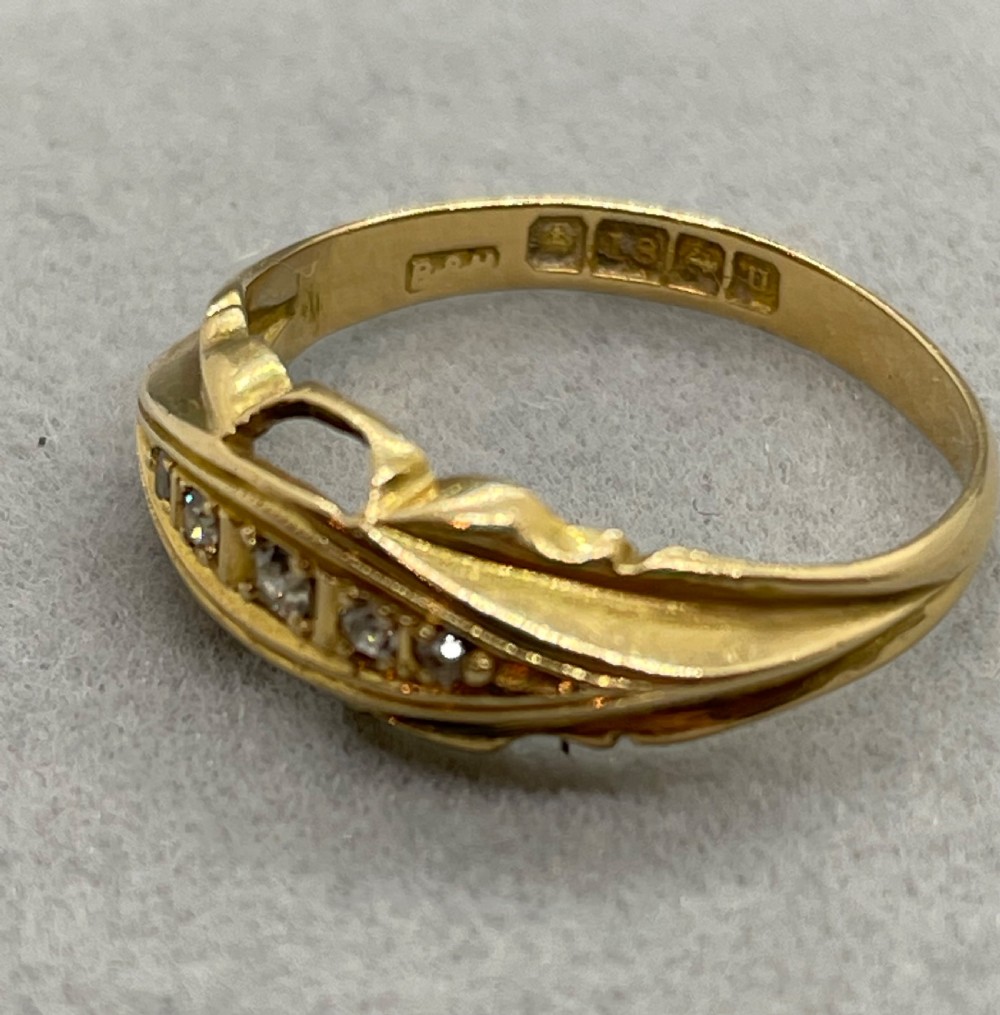An antique 18ct yellow gold ring featuring a row of inset diamonds set within a carved boat-shaped head. View IV