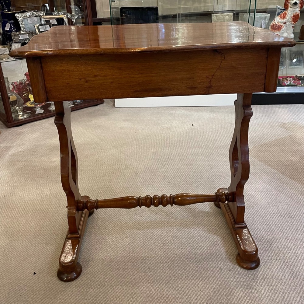 A 19th-century Victorian mahogany occasional table featuring a single drawer with wooden knobs, shaped trestle legs, and a turned stretcher. View III