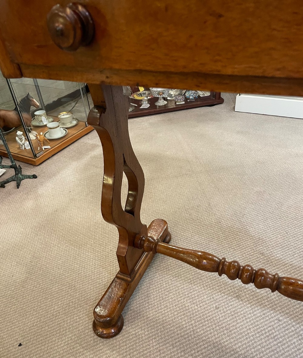 A 19th-century Victorian mahogany occasional table featuring a single drawer with wooden knobs, shaped trestle legs, and a turned stretcher. View VI